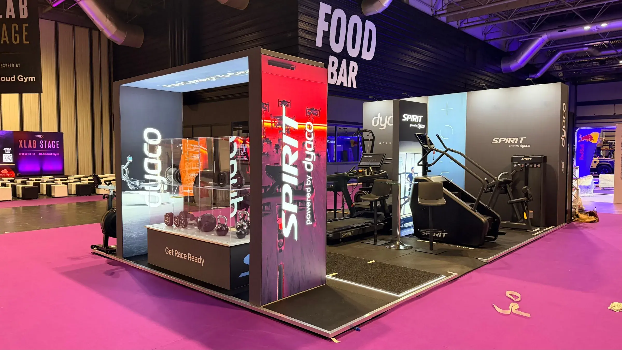 Dyaco's Performance Live stand with branded gym equipment displays