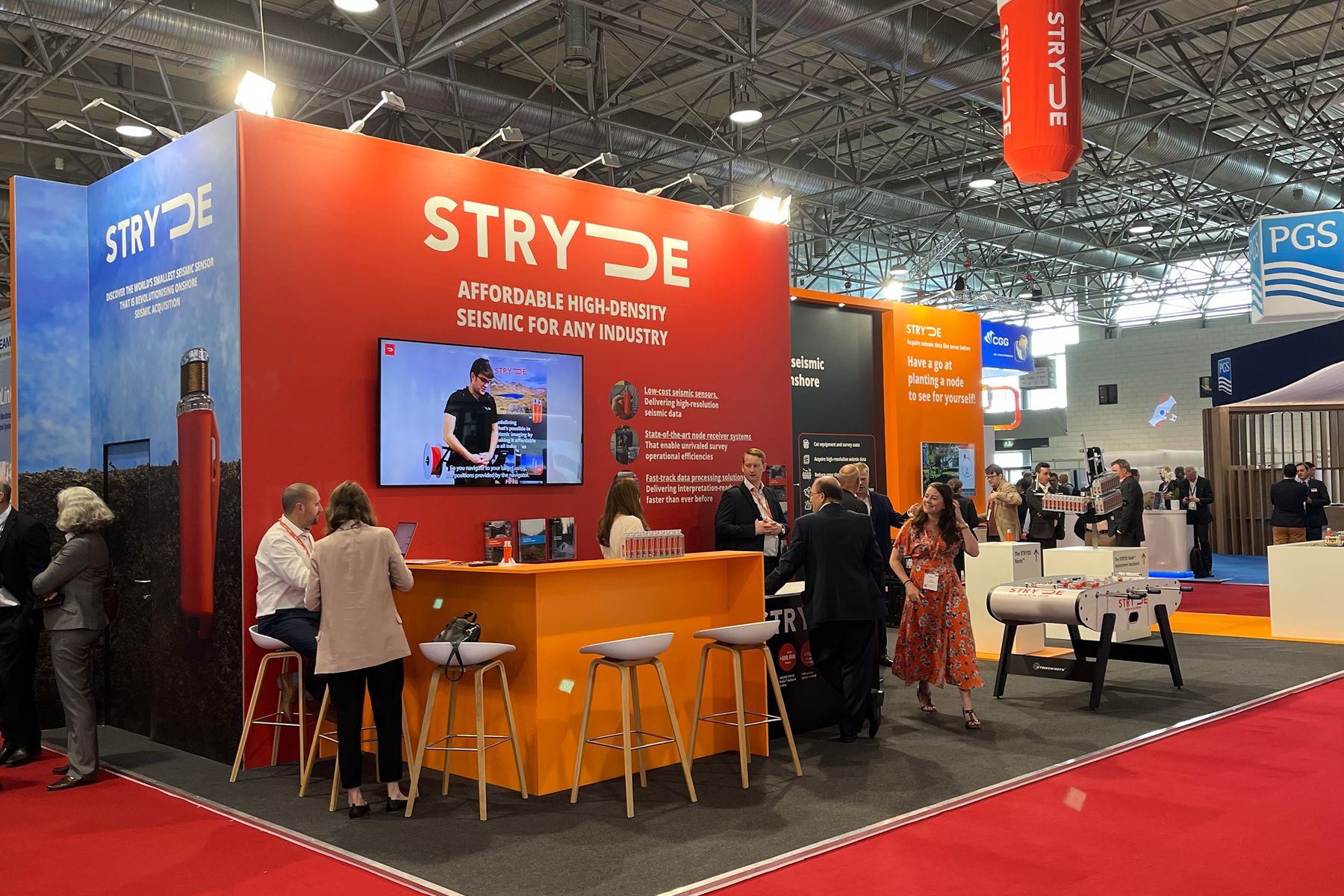 The orange counter and stool seating at the front of the STRYDE stand