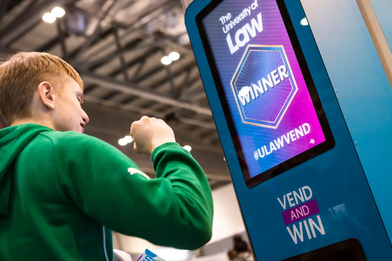 Student using The University of Law interactive vending machine at UCAS